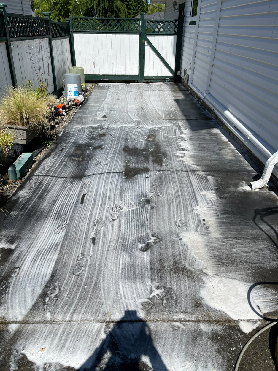 Dirty concrete pad before pressure washing
